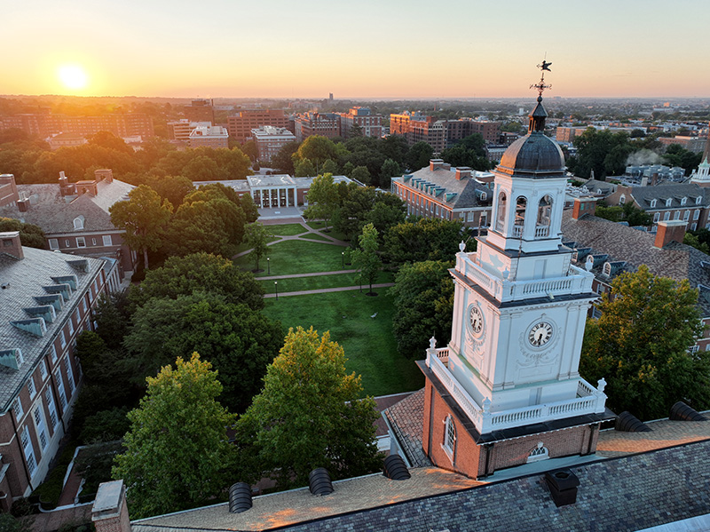 Aerial image of the Homewood Campus shortly after sunrise. Visible in the foreground is Gilman Hall and beyond that, the Keyser Quad and Milton S. Eisenhower Library.