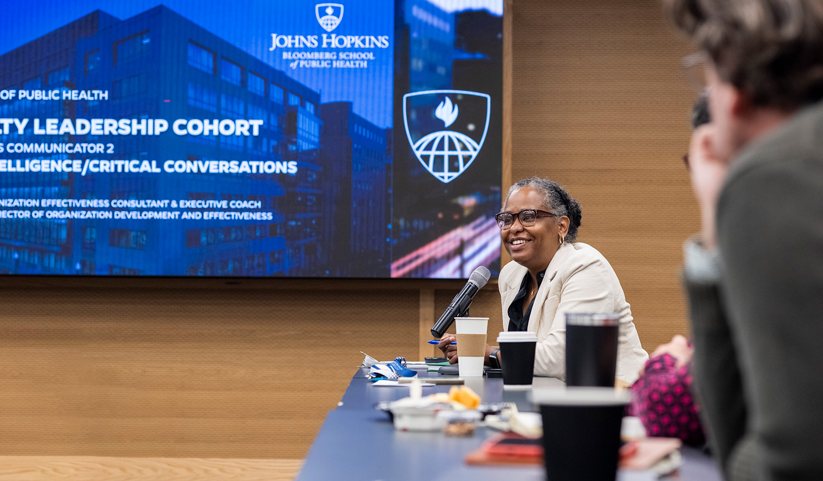 Image of a woman speaking in a conference room on a Johns Hopkins campus
